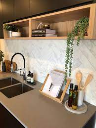 matt black kitchen with timber shelf detailing caesarstone sleek concrete benchtops and herringbone home decor styling interior design island counter