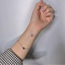 Internal peace and eternal peace inked on wrist. Heart Shaped Peace Symbol Tattoo On The Wrist