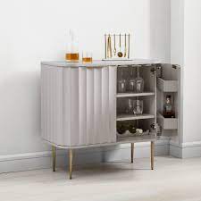 A home bar or cocktail bar is perfect for displaying your favorite spirits, while entertaining in style. Vivien Bar Cabinet
