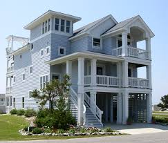 The main level consists of a double garage with room for storage, as well as a bedroom and full bath. The Kinnakeet Florez Design Studios