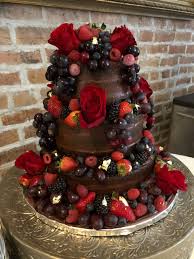 Using a pastry bag fitted with a coupler, pipe frosting around the perimeter. Three Tier Naked Chocolate Wedding Cake Chocolate Cake Filled With Chocolate Ganache And Chocolate Buttercream Then A Light Covering Of Fudge Icing On Top Fresh Red Roses Red Grapes Raspberries Strawberries Blueberries