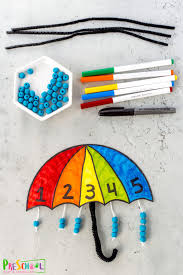 Pinch apart cotton balls for clouds. Spring Umbrella Counting Crafts For Preschoolers