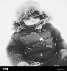 Monochrome Image Of Baby Girl Bundled Up In Snowsuit And Faux Fur Trapper Hat Outside In The Snow Stock Photo Alamy