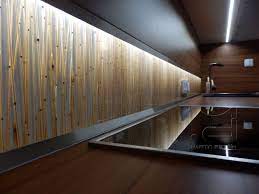 Stainless steel countertops and appliances make a crisp, industrial contrast against the rich wood finish. Back Splash Tiles With Organic Brown Bamboo Resin Acrylic Panel Panels Dekorakryl Kitc Acrylic Wall Panels Wall Architecture Interior Architecture Design