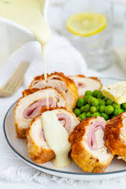 Ham and swiss cheese are wrapped up in a chicken cutlet, coated in breadcrumbs and baked to perfection. Chicken Cordon Bleu Recipe Video Cooked By Julie