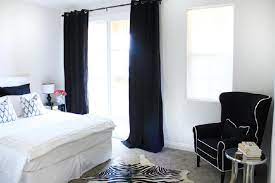 Black and white bedroom having striped bedding cover and matching curtains hung on the top of the bed, that oozes a lovely aura. Black Curtains Bedroom Ideas Novocom Top