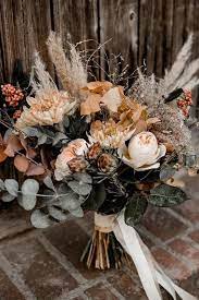 The seeded eucalyptus sprigs and feathery asparagus fern offer a play on texture that gives this bouquet a wild, rustic look. 35 Rustic Wedding Decorations You Must Have A Look Fall Wedding Bouquets Diy Bridal Bo Unique Wedding Bouquet Fall Wedding Bouquets Bohemian Wedding Bouquet