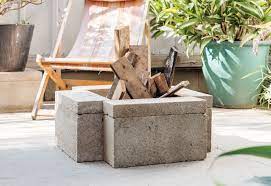 It is made from wood, bricks, fire glass, propane tank cover, wood glue, tape measure, drill, hinges, and barrel bolt lock. 10 Creative Diy Backyard Fire Pits
