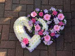 Double open heart funeral flowers. Pretty Double Open Heart Funeral Flowers Tribute In Pastel Shades Of White Pink And Lil Funeral Floral Arrangements Funeral Floral Funeral Flower Arrangements