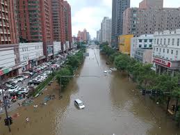 A man rides a bicycle through floodwaters on july 20, 2021, along a street following heavy rains in zhengzhou in china's central henan province. D9c36ma9loxv5m