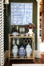 The chic piece features two open mirrored shelves for keeping drinks handy. Gold Bar Cart Detail In Formal Dining Room By Amanda Reynal Interiors Lookbook Bar Cart Decor Formal Dining Room Home Decor