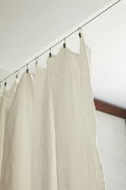 Curtains come in a range of fabrics, and almost any of these will work as room dividers. A Simple Curtain Hides A Murphy Bed Divides A Room Room Partition Simple Curtains Curtain Divider