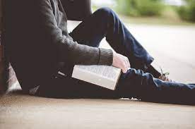 Free Photo | Young Male Sitting On The Ground And Holding The Bible In His  Hands