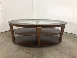 The lower shelf is crafted from tempered glass,. Oea Auctions Oval Glass Top Coffee Table On Wheels