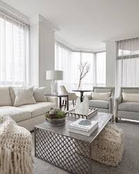Light Themed Transitional Living Room Cozies Up With An Ivory Sofa Paired With Gray Accent Chairs Living Room Grey Living Room Themes Transitional Living Rooms