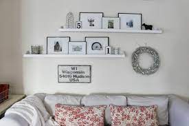 Feb 20, 2012 · toward the side of the room with the lower ceilings and perhaps over the sofa, consider using a large piece of art or a gallery wall that fills about 2/3 of the vertical wall space. Happy At Home Living Room S Winter Decor Shelves Above Couch Above Couch Living Room Shelves