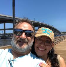 Who can I contact to pick up a trapped raccoon in Palm Bay, FL without  paying a private company?