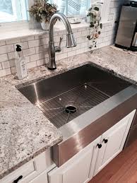 White Kitchen Cabinet Makeover With Stainless Steel Farmhouse Sink Farmhouse Sink Kitchen Replacing Kitchen Countertops Kitchen Cabinet Design