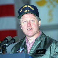President William Jefferson Clinton shakes hands with a Marine officer  aboard the nuclear-powered aircraft carrier USS THEODORE ROOSEVELT (CVN-71)  as the vessel is underway off the coast of Norfolk, Va. Clinton is