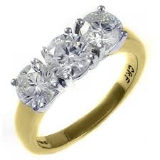 Stunning three stone ring crafted in platinum and 18 karat yellow gold, featuring a stunning deep red oval ruby weighing approximately 1.8 carats, flanked. 18ct Yellow Gold 1 00ct Round Brilliant Diamond 3 Stone Ring Jewellery From Mr Harold And Son Uk