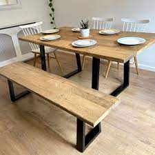 Featuring looped metal legs, and a black coated wooden table top, it's sure to elevate your dining room look. Reclaimed Wood Trapezium Industrial Dining Table
