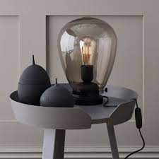 Obscured, clear and smoked glass dining tables, coffee tables, and tea tables are perfect for the occasions when an upscale patio setting is desired. Belid Dolores Table Lamp With Black Metalwork And Smoked Glass