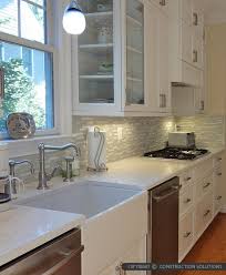 These quartz white worktop are high on demand and are a staple favorite of architects and interior designers alike. White Kitchen With White Tile Novocom Top
