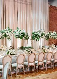 Grand Head Table At Wedding Reception Featured Tall Centerpieces Of All White Flowers On Table Flower Arrangements White Flower Arrangements Tall Centerpieces