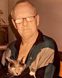 This is a personal family photo of the man we all loved to hate, Frank  Burns of M*A*S*H or the great Larry Linville in his home with his kitty.  This picture was