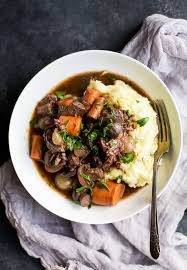 Beef bourguignon made with pearl onions, carrots, mushrooms, beef, and burgundy red wine is a classic comfort food that's hearty, filling, and perfect for when it's cold outside! Easy Beef Bourguignon Recipe Slow Cooker Comfort Food