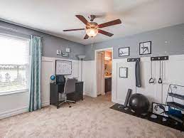 Dumbbells, wal bar, exercise bench and kettlebells. Combine An Office And Workout Room Into One Dual Use Work Space Highland Homes Model Home In Sarasota F Workout Room Home Gym Room At Home Small Home Gyms