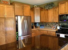 White and brown kitchen features white upper cabinets and brown distressed lower cabinets paired with fantasy brown granite countertops and a linear marble tiled backsplash. Corner Kitchen Cabinet Ideas Search For A Good Cause