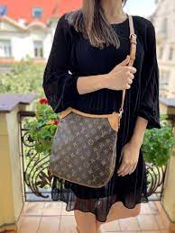 The odeon pm features a monogram canvas body with vachetta leather trim, flat strap, top zip closure, exterior slip pocket, and interior slip pockets. Louis Vuitton Odeon Pm Monogram Canvas Luxury Bags
