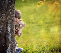 Five smiling friends peeking out from behind a tree and looking at the camera. Little Girl Hugging Teddy Bear Hiding Behind Tree Stock Photo Free Download