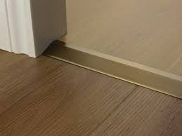 Installing a t mold transition between laminate and ceramic tile there are several different types of laminate transitions that you may need when other transitions are used where the laminate ends at carpet, vinyl flooring, a threshold or a step down such as a sunken living room or stairs. Door Threshold Bars Shop Our Massive Range Of Quality Door Bars