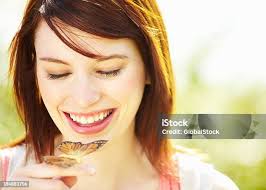 Natural Woman With Monarch Butterfly On Nose Stock Photo
