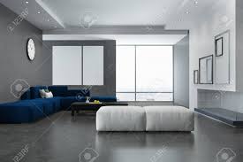 A small, circular side table fits underneath a large coffee table, so you can spread them out around the room for a cohesive look, or save space until company comes over. Concrete Wall Living Room Interior With A Concrete Floor A Blue Stock Photo Picture And Royalty Free Image Image 96213229