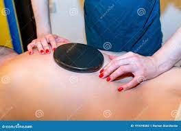 Japanese Back Massage with Warm Black Stones in the Massage Parlor Stock  Photo 