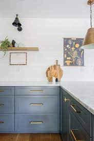 Modern Kitchen With Slate Blue Cabinets White Countertops And Gold Accents Blue Cabinets Luxury Kitchen Design Blue Kitchen Designs