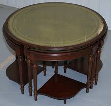38 inch retro style round wooden coffee table with bottom shelf in natural brown. Vintage Mahogany And Green Leather Topped Coffee Table Plus 4 Nest Of Small Tables At 1stdibs