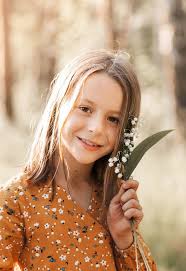 Beautiful School-age Girl with Lily of the Valley Flowers in Her Hand.  Summer, Sunset Stock Image