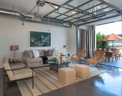 This garage conversion blends a home office and a small seating area complete with a couch for guests. You Ll Never Believe These 19 Rooms Were Once Garages Garage To Living Space Garage Bedroom Garage Room Conversion