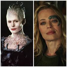 Why is Seven of Nine still referred to by her Borg designation and wears  the implant over her eye?