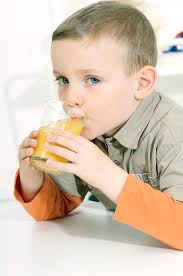 This is a vintage federal glass orange juice decanter with cover and four matching glasses. Boy Drinking Orange Juice Photograph By Lea Paterson Science Photo Library