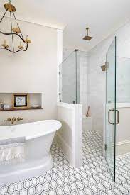 Floor Level Shower With White Gray And Black Geometric Floor Tiles Featuring A Zero Entry Glass Enclosed Shower Floor Tile Glass Shower Doors Geometric Floor