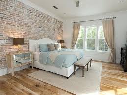 In the bathroom, a stone shower has horizontal tiling. Exposed Brick In Bedroom Brick Bedroom Brick Wall Bedroom Home Bedroom