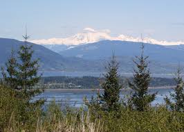 The trail crosses the private property on a donated easement before reaching the skagit land trust's 70 acres around the summit. 135 Guemes Mountain Trail Sixty Before Sixty