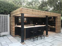 Don't leave your grill lonely on the edge of your deck — pending your budget, a full outdoor kitchen and bar create a homey and familiar outside hangout spot. Bar Grill Outdoor Kitchen Design Patio Design Diy Outdoor Kitchen