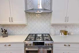 This customer used the white shaker elite cabinet line to create an elegant transitional space. White Shaker Kitchen Cabinet With Arabesque Gloss Tile Backsplash White Shaker Kitchen White Shaker Kitchen Cabinets Shaker Kitchen