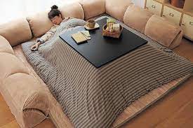 A kotatsu is a low, wooden table frame covered by a futon or heavy blanket, upon which a table top sits. Japanese Kotatsu Table With Heated Blanket Man Of Many